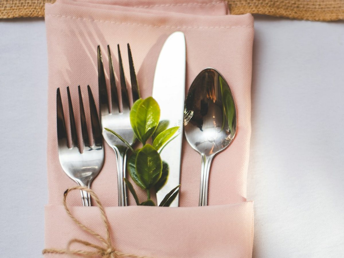 Cutlery tucked into a pocket-folded napkin (illustrative photo)